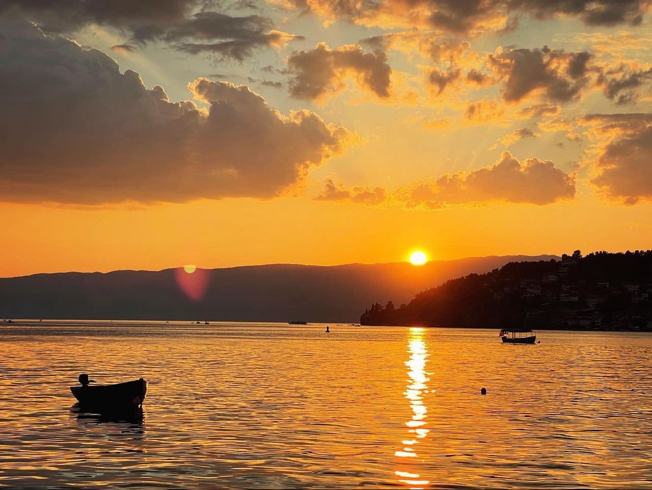 Golden sunset over Lake Ohrid with small boats on the water